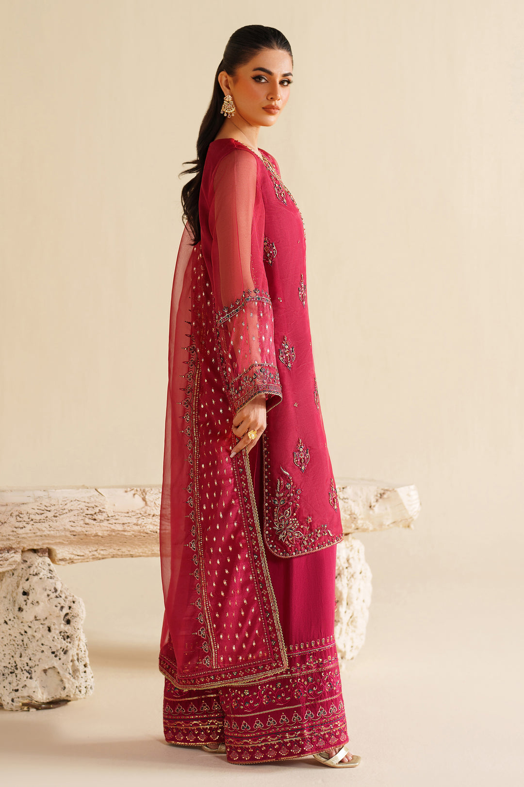 Side view of NAQSHI deep red formal dress highlighting elegant shape, rich embroidery, and event-ready finish
