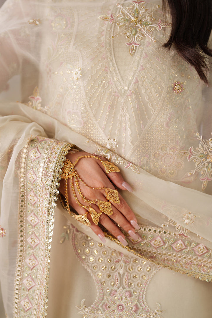 Close up of NAQSHI Seemal cream embroidered dupatta and sleeve detail on formal dress for weddings and party events.