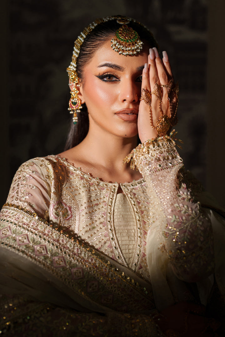 Close portrait shot of NAQSHI Seemal cream formal outfit showing detailed neckline and embroidery for wedding celebrations.
