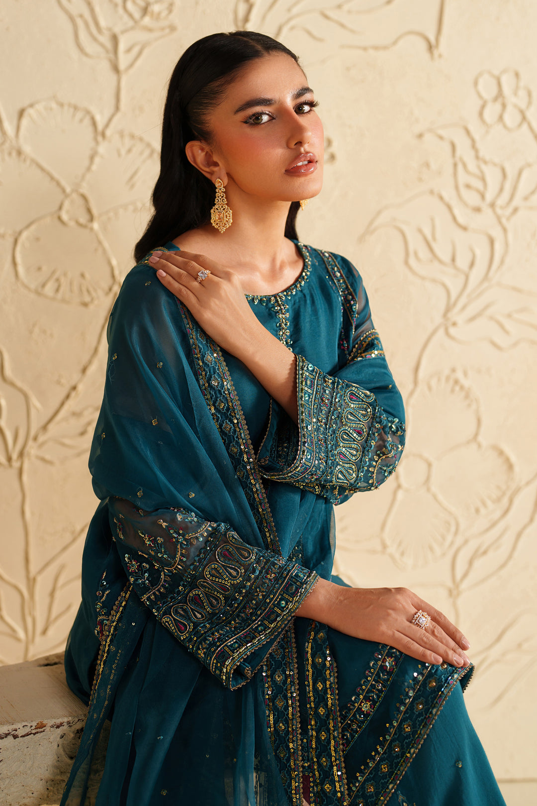 Upper body view of NAQSHI deep teal dress with embroidered sleeves and refined festive styling