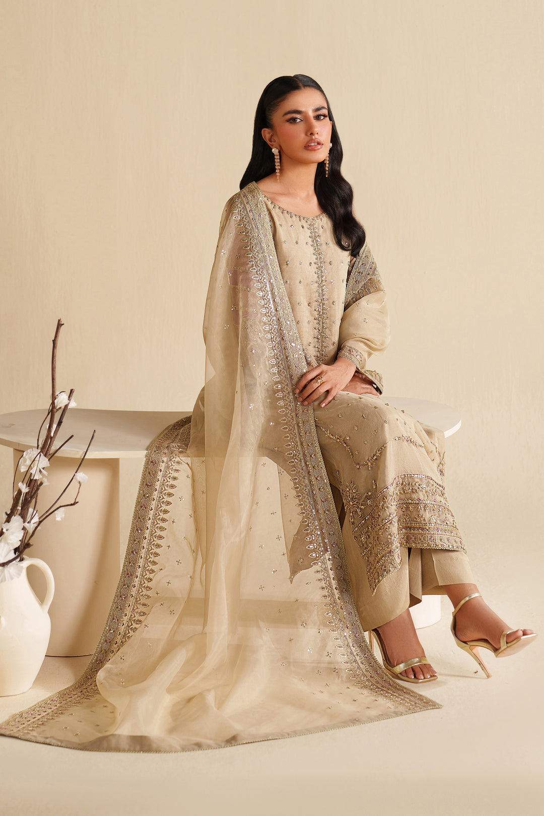 Close-up of NAQSHI ivory beige formal dress showing fine embroidery on fabric and sleeves with premium stitched quality