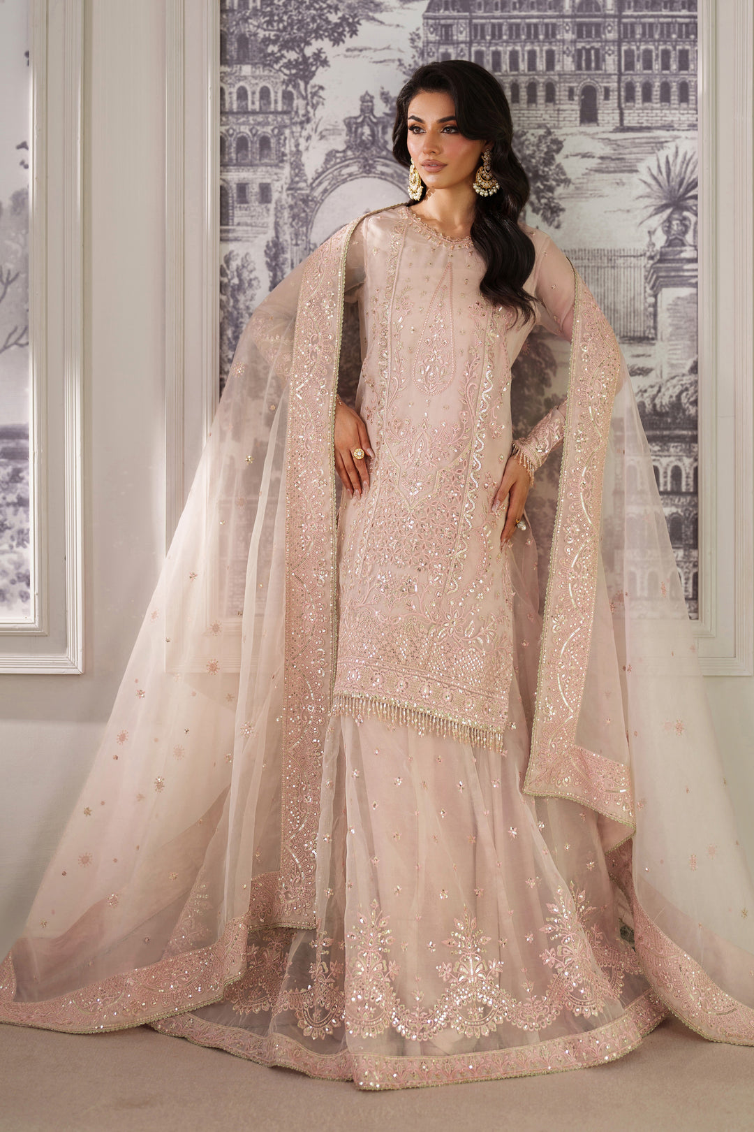 Zri by NAQSHI styled ensemble showcasing draped dupatta and graceful silhouette in peach organza