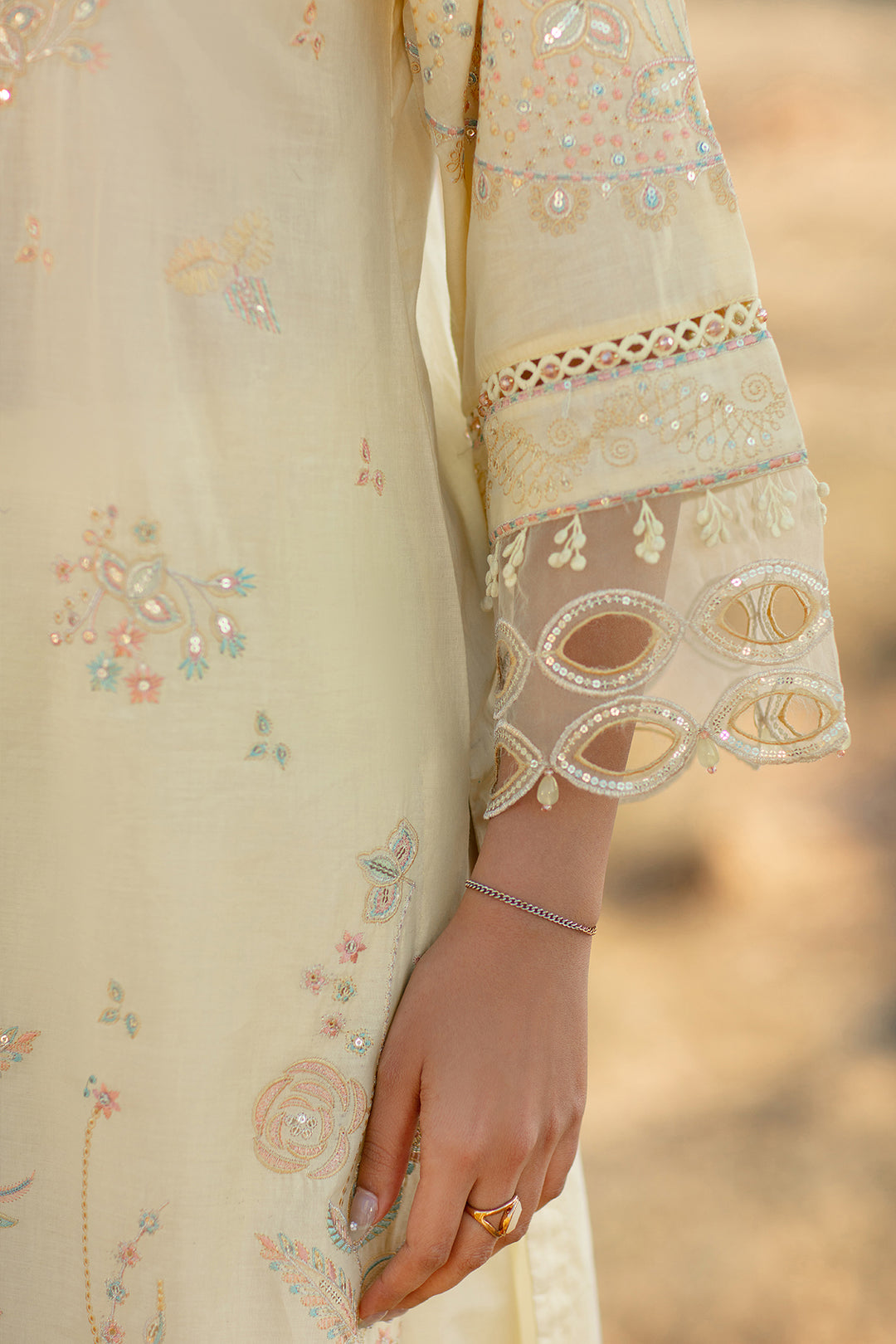 Detailed close up of sleeve embroidery organza boring and hanging lace on Nazakat light yellow ready to wear outfit