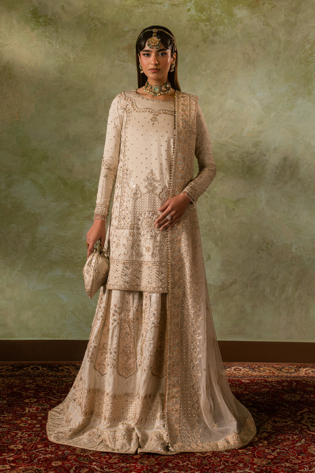 Full standing look of Damiya off white sharara suit highlighting balanced silhouette and clean embroidery detailing, formal ready made Nikkah outfit.