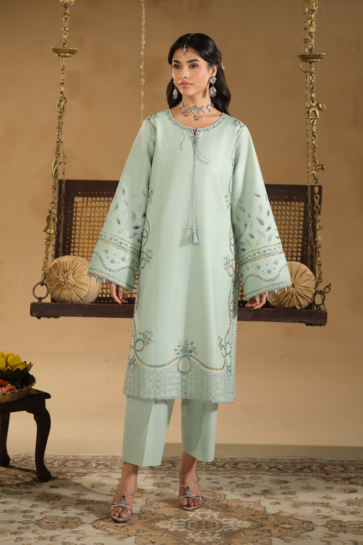 Standing look of Kiswa Eid outfit highlighting embroidered sleeve borders and clean straight silhouette
