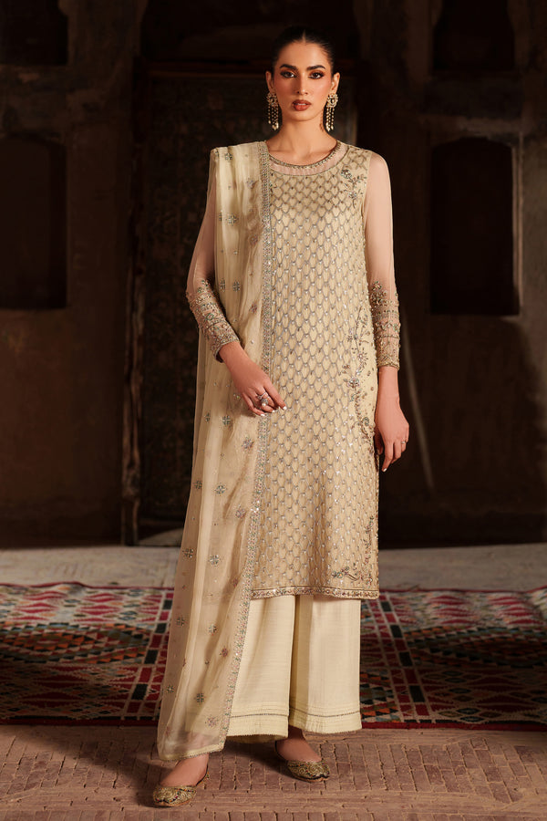 Woman wearing a traditional outfit with intricate patterns in a warm-toned setting.