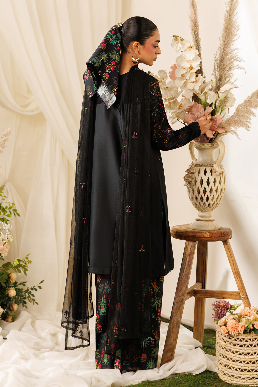 Back view of NAQSHI Halia outfit highlighting long shirt fall, net dupatta drape, and printed culottes