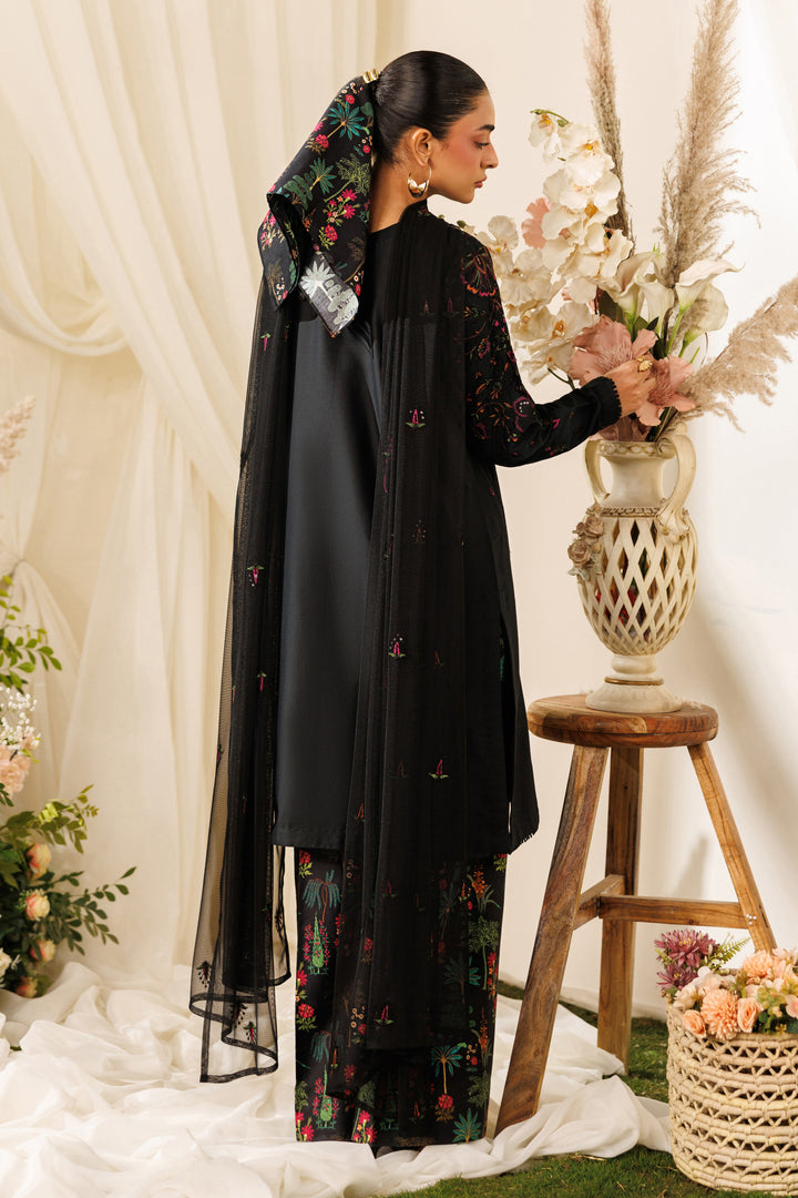 Back view of NAQSHI Halia outfit highlighting long shirt fall, net dupatta drape, and printed culottes