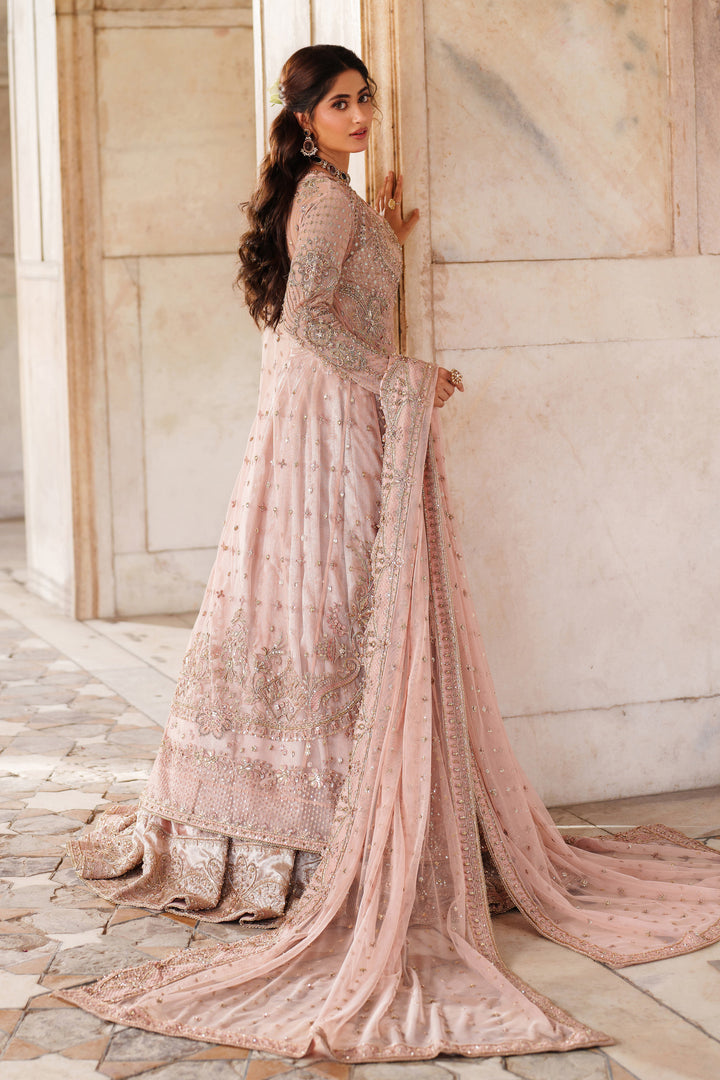 Back view of NAQSHI Mareeha embroidered soft pink formal gown with long flared silhouette and delicate motifs for special occasion wear.