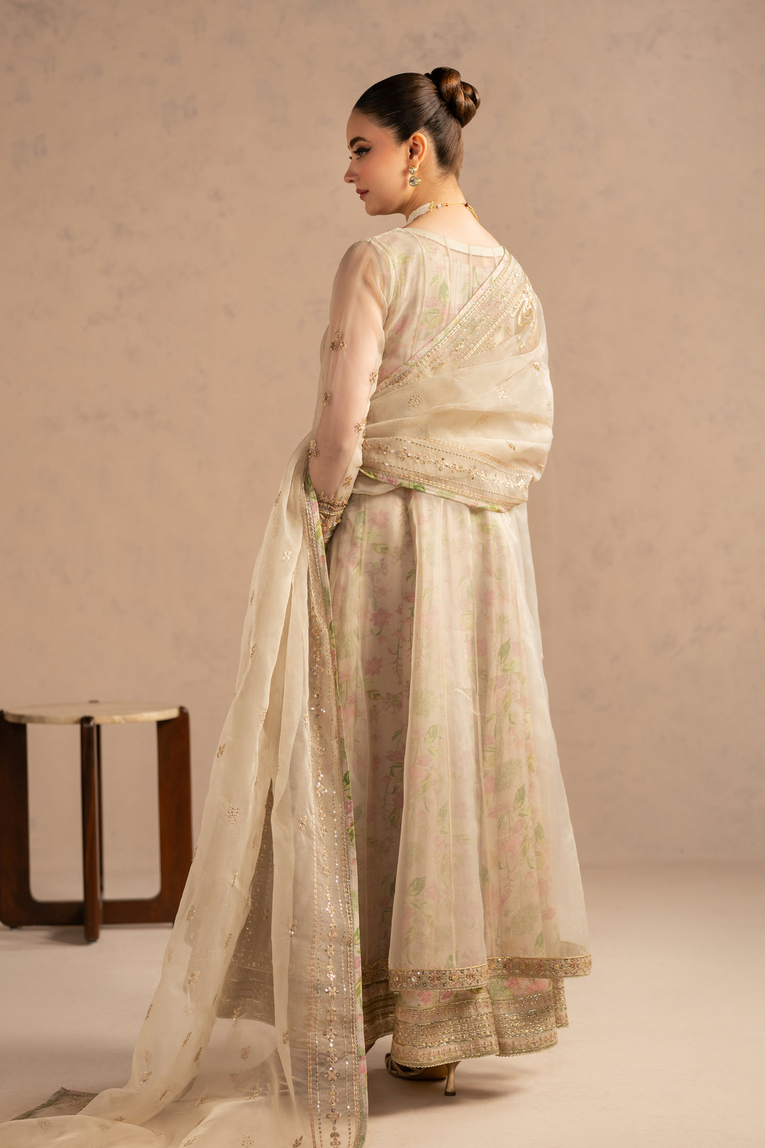 Back view highlighting smooth flare and layered organza fall with inner lining support.