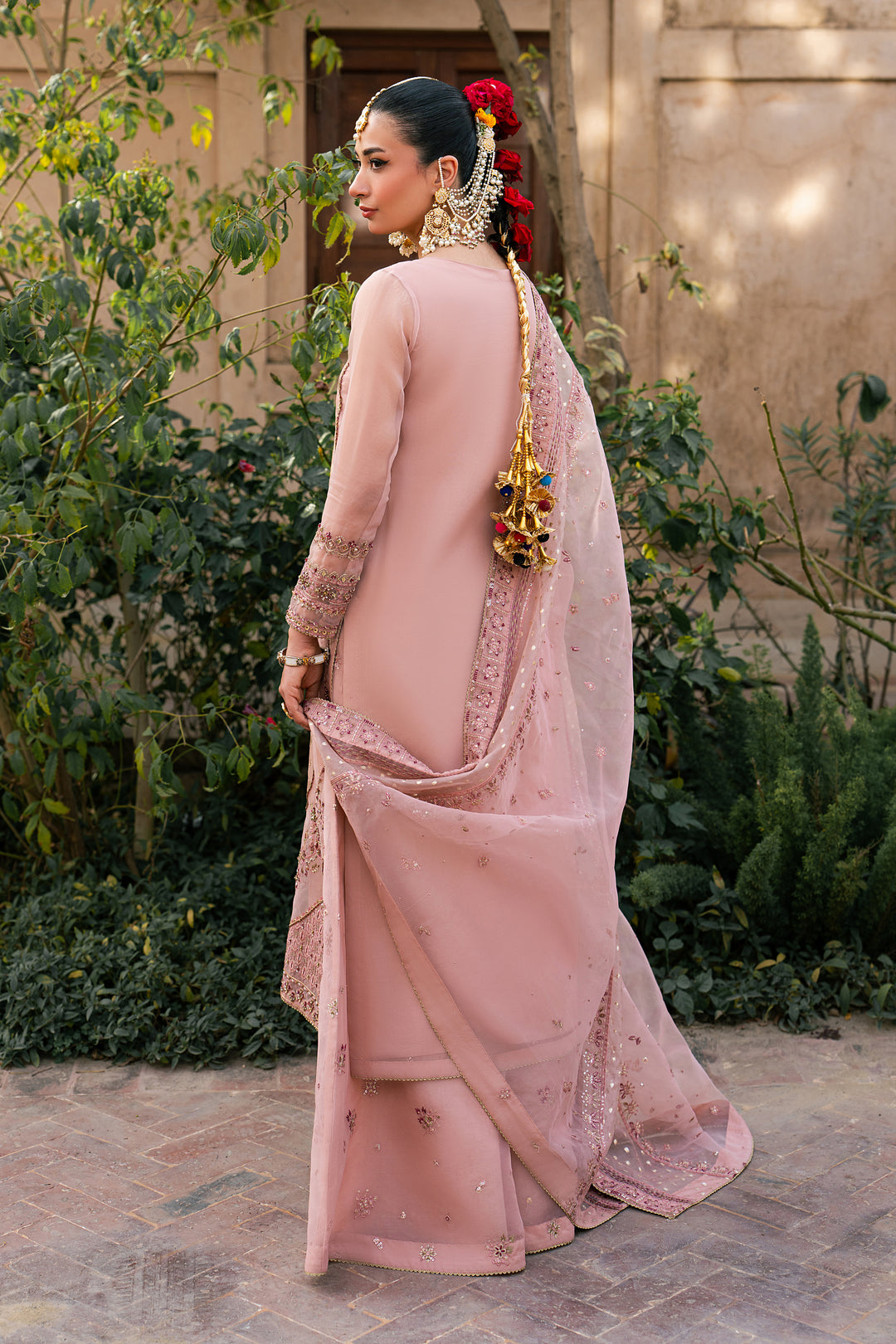 Back view of Faris peach organza semi formal outfit with embroidered long shirt, flared trousers and organza brochia dupatta