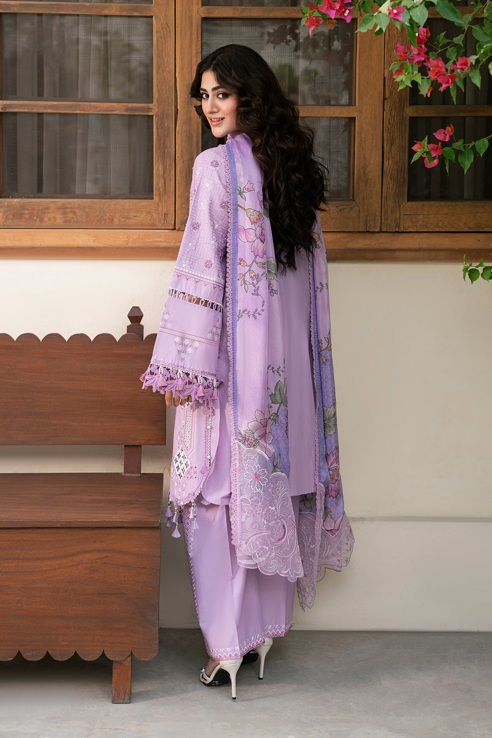 Side view of Izna lilac embroidered lawn suit featuring floral embroidery, relaxed silhouette and tissue silk printed dupatta for summer wear