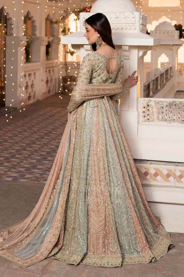 Woman in a traditional outfit standing in front of an ornate architectural structure.