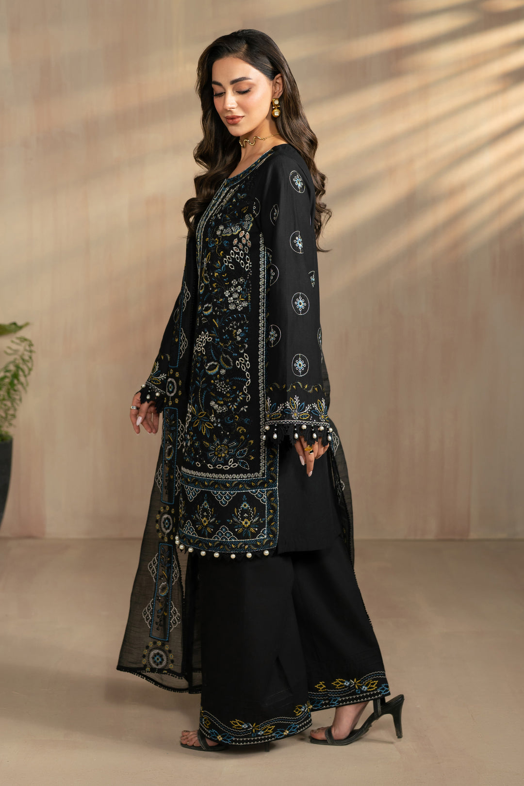 Side standing pose of Hazeem outfit showing straight shirt silhouette and embroidered borders, lightweight ready made eastern summer attire.