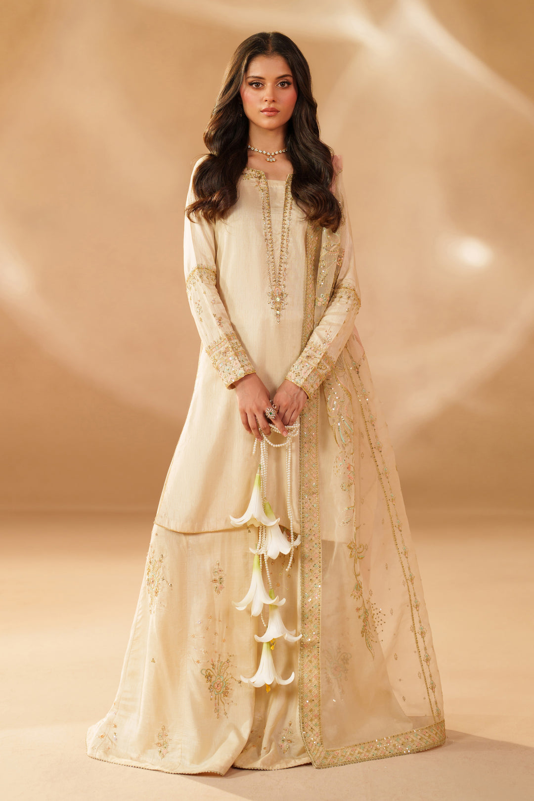 NAQSHI Mawrah beige Indian raw silk and organza 3-piece sharara outfit with detailed embroidery and contrast applique work for weddings and festive events.