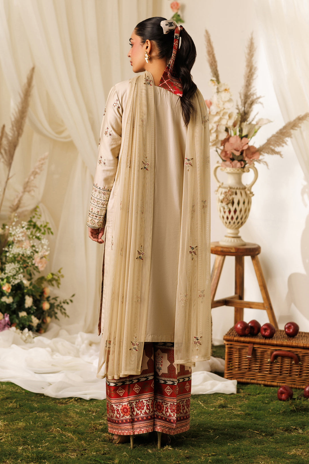 Side standing view of NAQSHI Numa outfit showing straight shirt cut, light beige tone, and printed culotte trousers