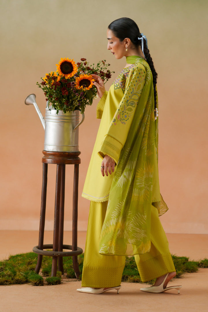 Side view of Deniz lime embroidered lawn outfit with printed crinkle chiffon dupatta and cambric shalwar for festive casual wear.