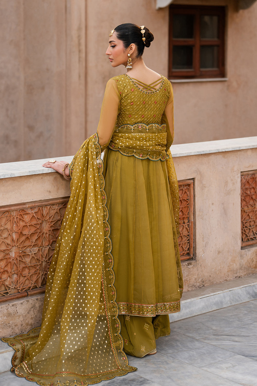 Back view of Lehr mustard organza panelled frock with flared trousers and zari organza dupatta from NAQSHI festive collection