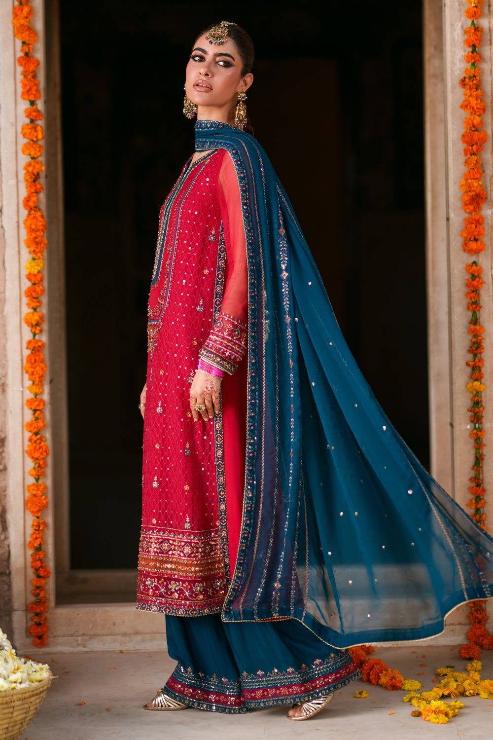Side view of Shazim crinkle chiffon semi formal outfit featuring shocking pink shirt, zinc contrast dupatta and PK raw silk culotte trousers