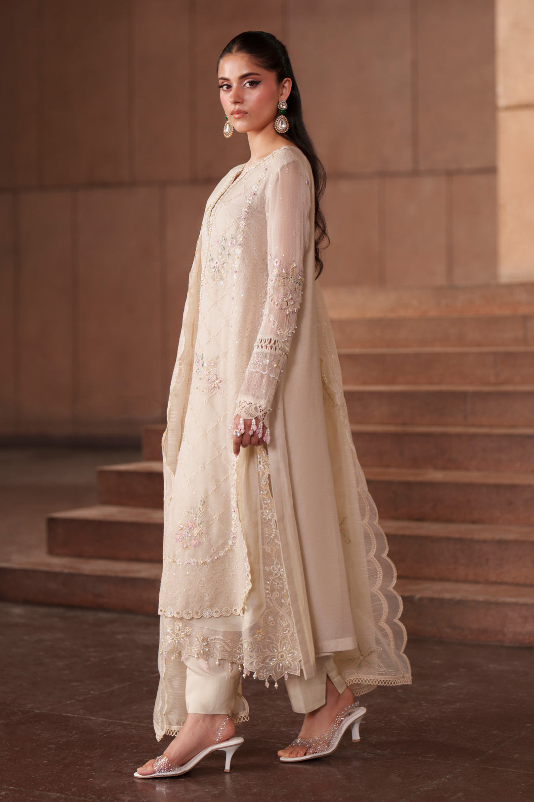 Side view of Ingrid off-white embroidered khadi net dress featuring long flowing silhouette, straight trousers and elegant cotton organza dupatta