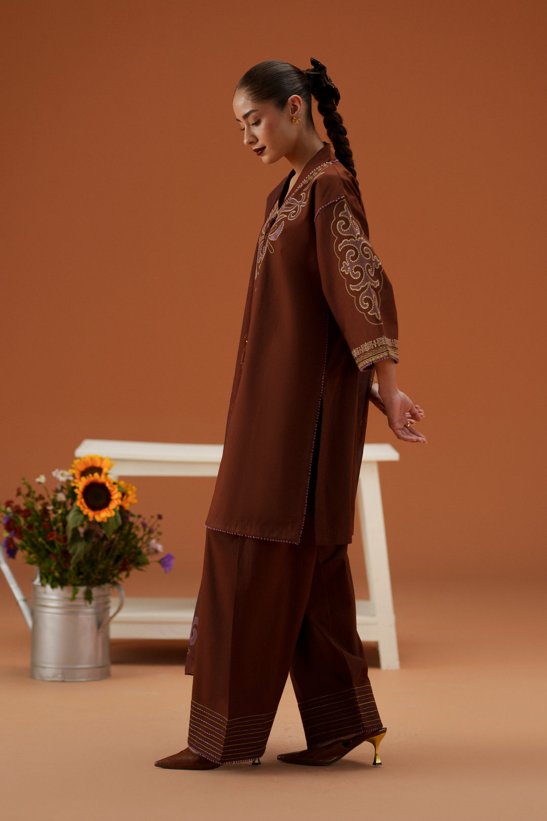 Side view of Fiona brown embroidered lawn outfit with printed crinkle chiffon dupatta and cambric shalwar for festive casual wear.