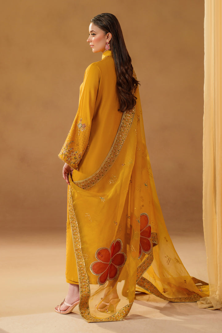 Side and back view of NAQSHI Marlyin mustard yellow luxury pret dress with long embroidered dupatta, showing full outfit flow and detailed design