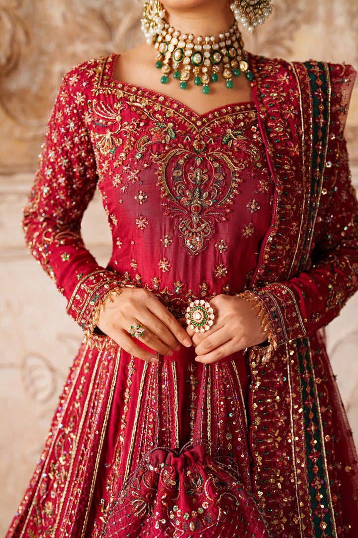 Close up of NAQSHI Gul Kand embroidered bodice and neckline showing fine thread and sequin work on red bridal outfit.