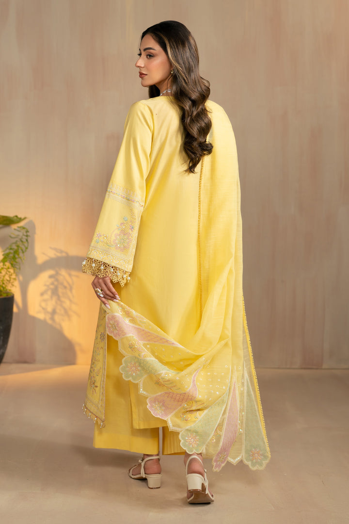 Walking side view of Sheiza yellow dress highlighting lightweight cotton organza dupatta and relaxed culotte trousers, breathable summer ready outfit.