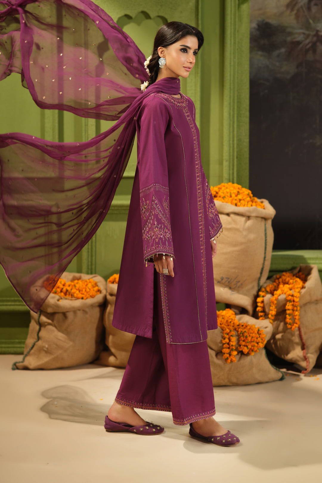Side view of NAQSHI Huram plum embroidered Pima lawn shirt paired with cambric culotte trousers and crinkle dupatta