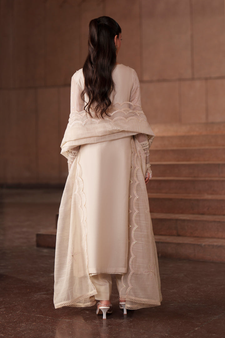 Back view of NAQSHI Ingrid off-white luxury pret outfit showcasing graceful flare, embroidered detailing and lightweight organza dupatta drape