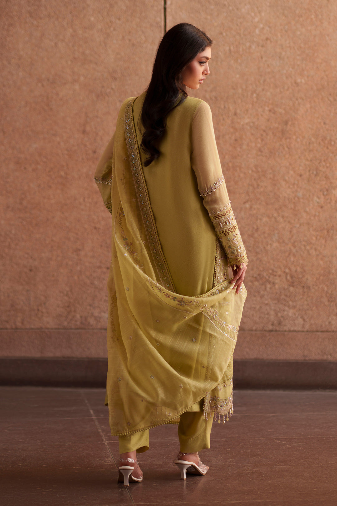 Side profile of NAQSHI Pedro lime green luxury pret outfit showcasing flowing open gown silhouette and embroidered cotton organza dupatta