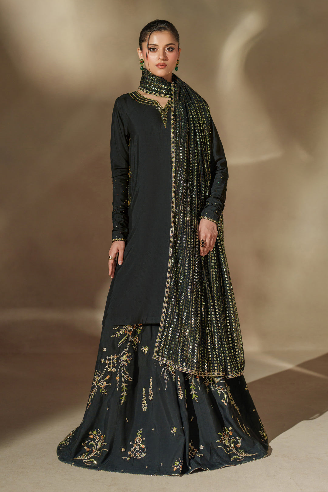 Front angle of NAQSHI Misam luxury black sharara outfit highlighting detailed embroidery and rich raw silk fabric for weddings and special celebrations