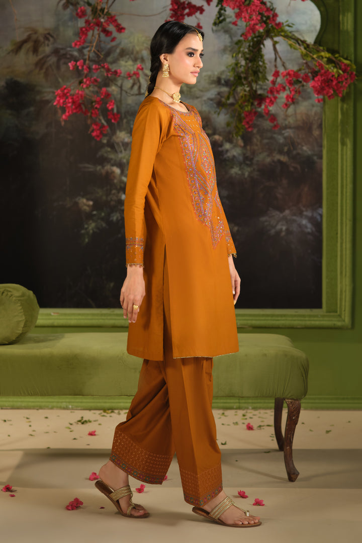 NAQSHI Ordhni rust three piece outfit showing straight Pima lawn shirt with cambric trousers and flowing net dupatta