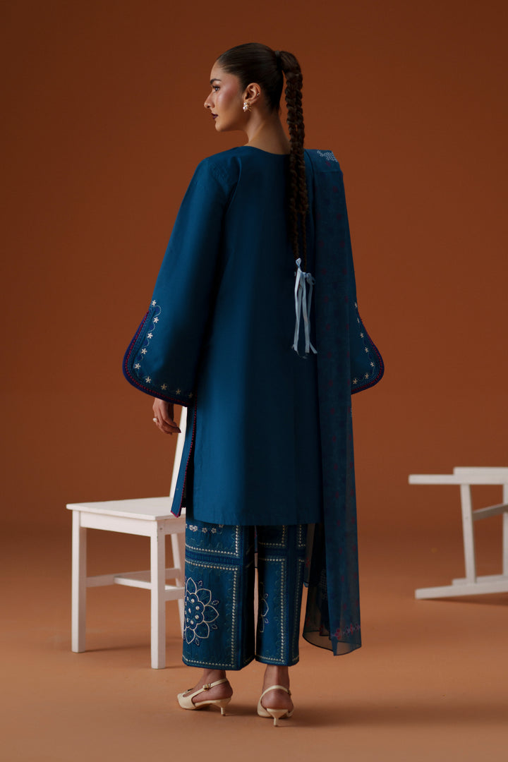 Back view of Juni teal ready-to-wear dress showing straight lawn shirt, printed crinkle chiffon dupatta, and embroidered culotte trouser.