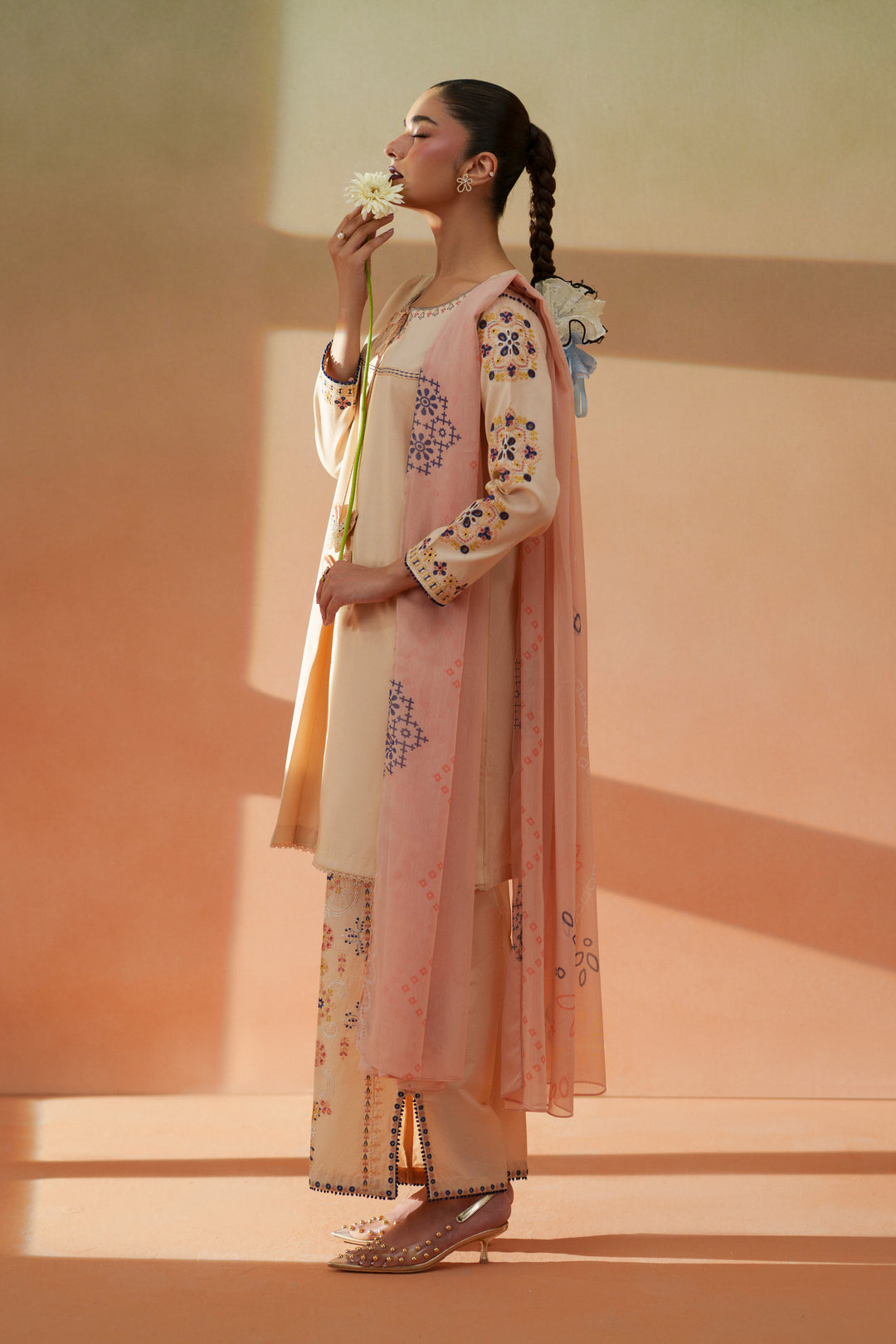 Side view of Faye light peach ready-to-wear dress showing A-line lawn shirt, embroidered culotte trouser, and soft printed dupatta.