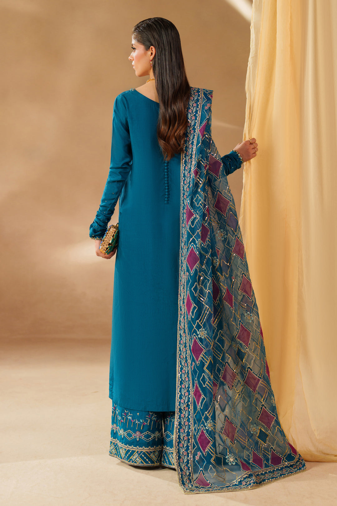 Side and back view of NAQSHI Anaiza zinc dress showing buttoned back neckline, flowing extended sleeves and printed organza dupatta for special celebrations