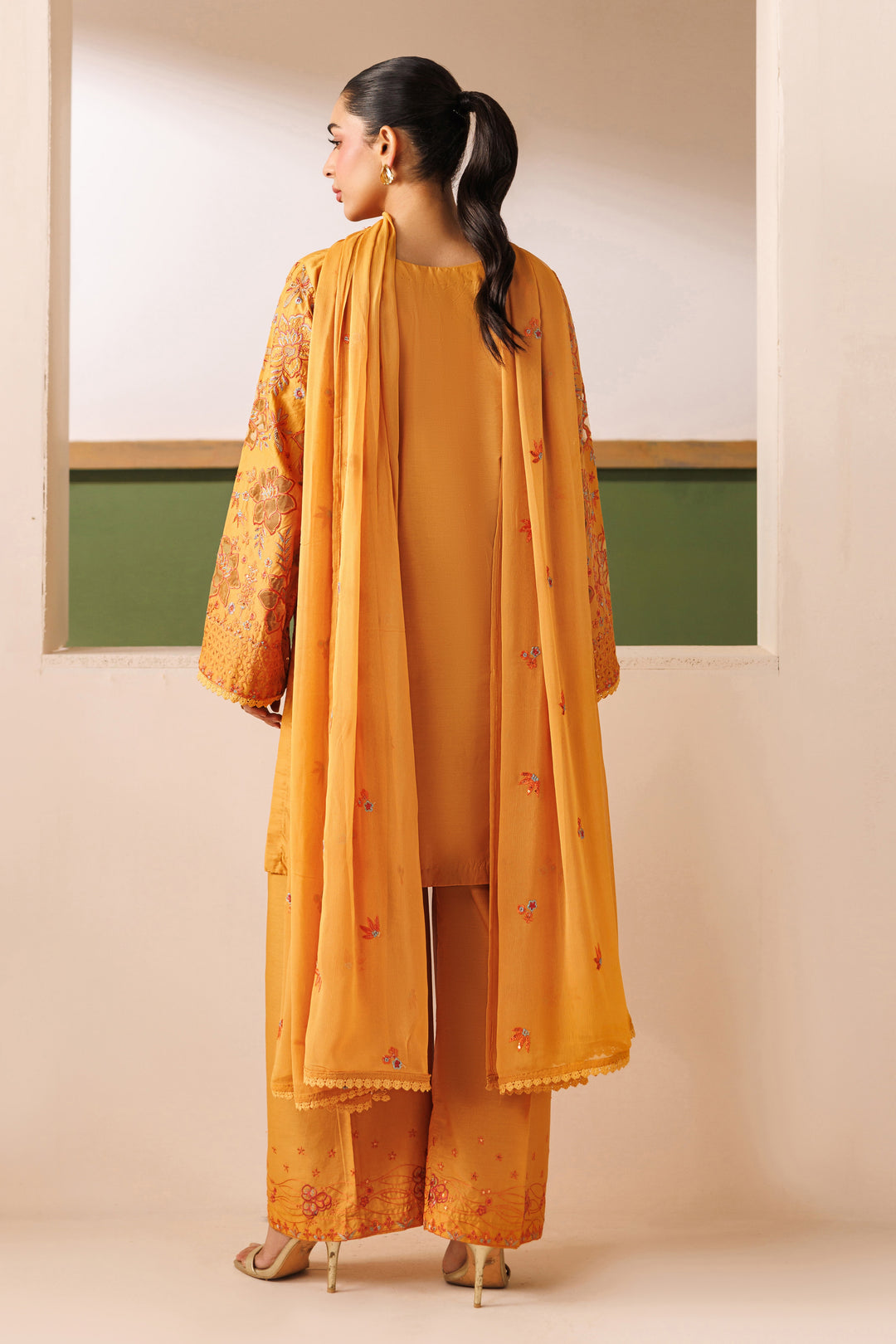Back view of NAQSHI Lunara outfit showing cambric shirt fall, loose sleeves, and flowing crinkle dupatta