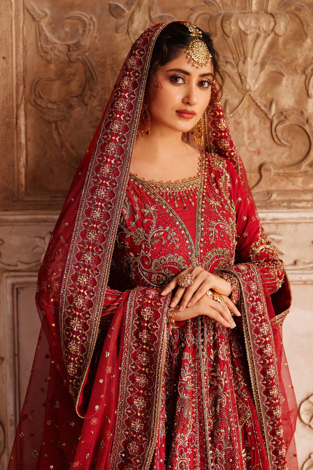 Wide skirt spread of NAQSHI Zeban red bridal lehenga showcasing rich embroidery and flare for wedding and reception events.