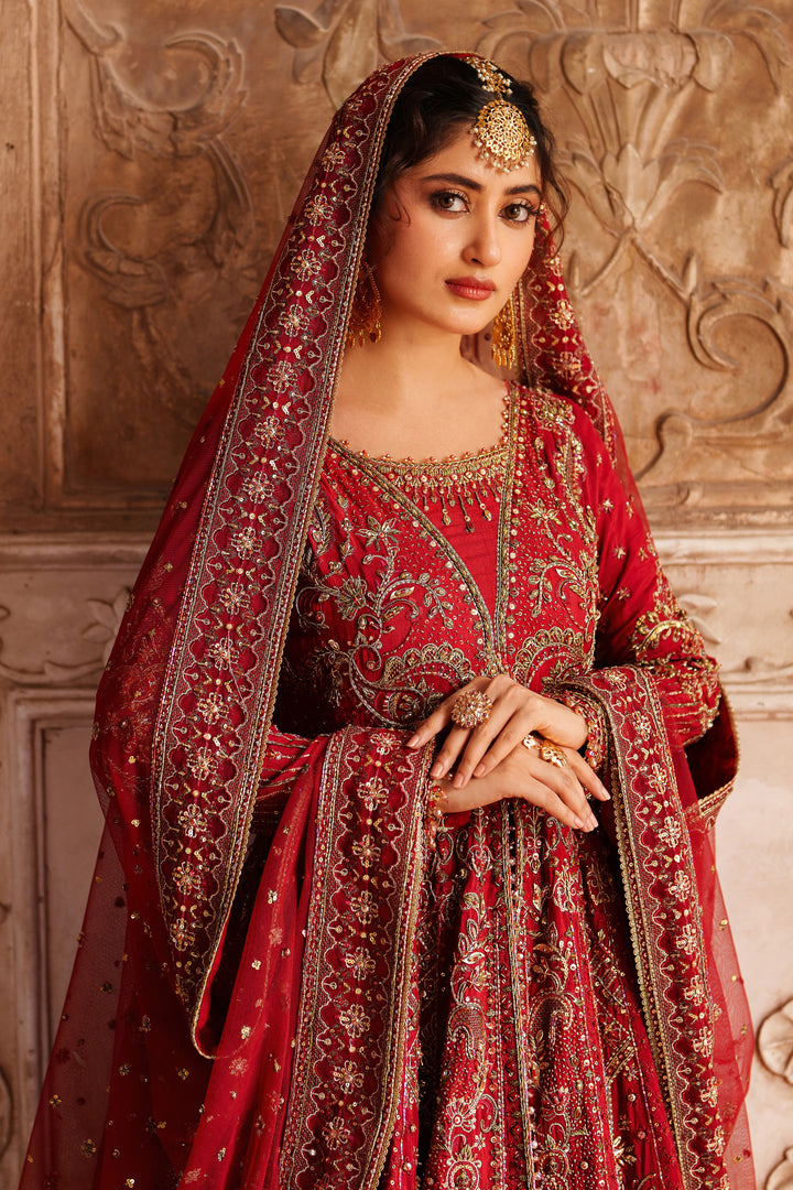 Wide skirt spread of NAQSHI Zeban red bridal lehenga showcasing rich embroidery and flare for wedding and reception events.