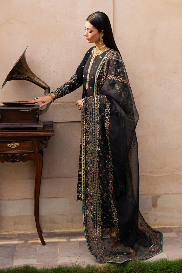 NAQSHI Gul-e-Tesnim side pose – showcasing structured silhouette and full sleeve embroidery in black silk
