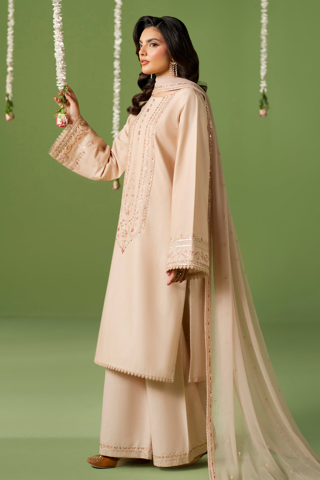 Side standing view of NAQSHI Seema outfit highlighting straight shirt cut, loose sleeves, and simple summer styling
