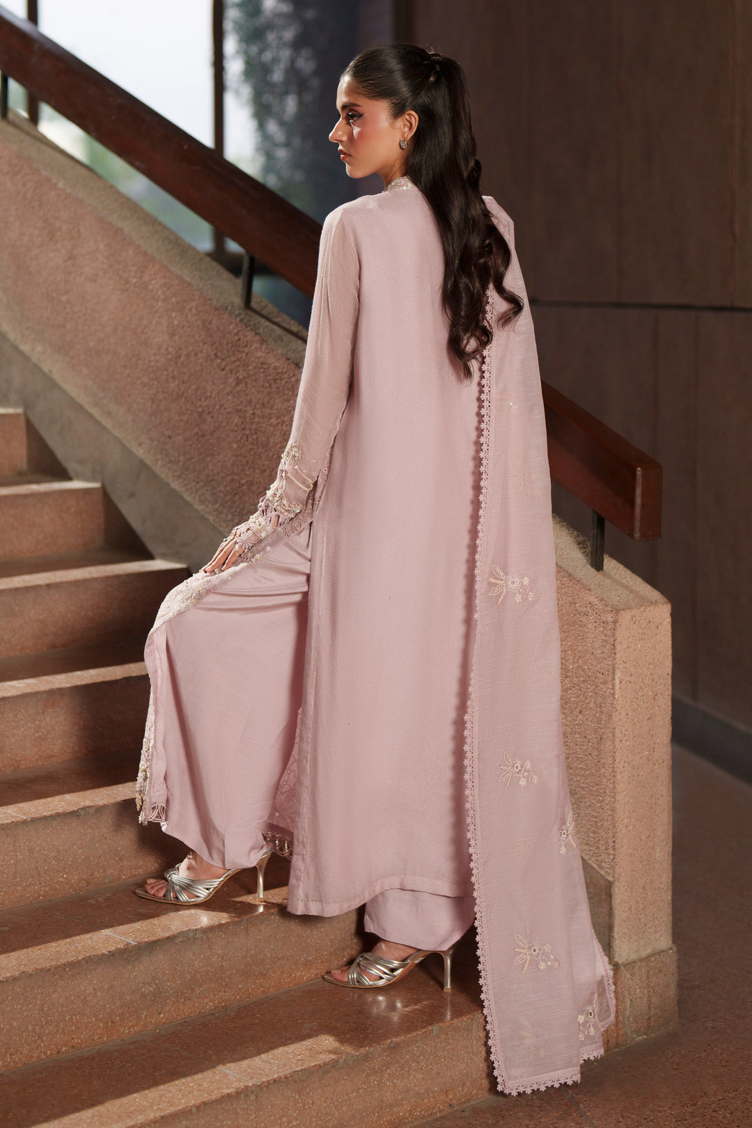 Side profile of NAQSHI Anahi lilac luxury pret outfit showcasing elegant movement, embroidered detailing and flowing organza dupatta