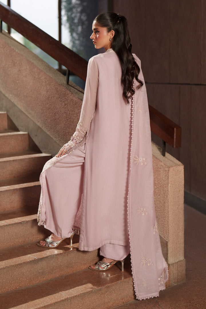 Side profile of NAQSHI Anahi lilac luxury pret outfit showcasing elegant movement, embroidered detailing and flowing organza dupatta