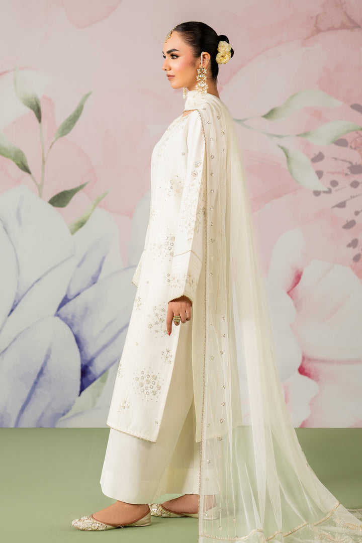 Side standing view showing off white long shirt with culotte trousers and embroidered dupatta semi formal dress