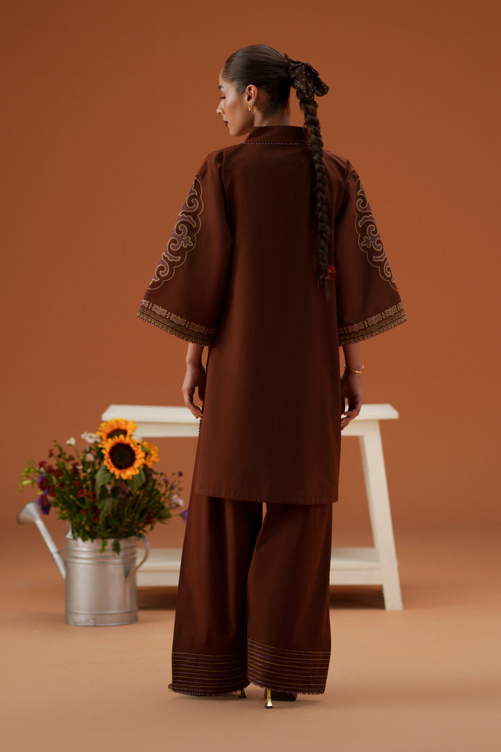 Back view of Fiona brown ready-to-wear dress showing relaxed lawn shirt, cambric shalwar, and flowing printed chiffon dupatta.