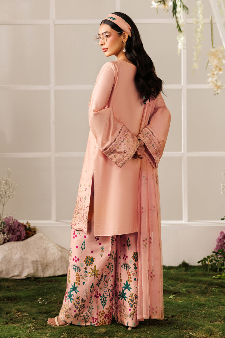 Side angle view of NAQSHI Hoorish outfit showing clean shirt cut, soft peach tone, and relaxed silhouette