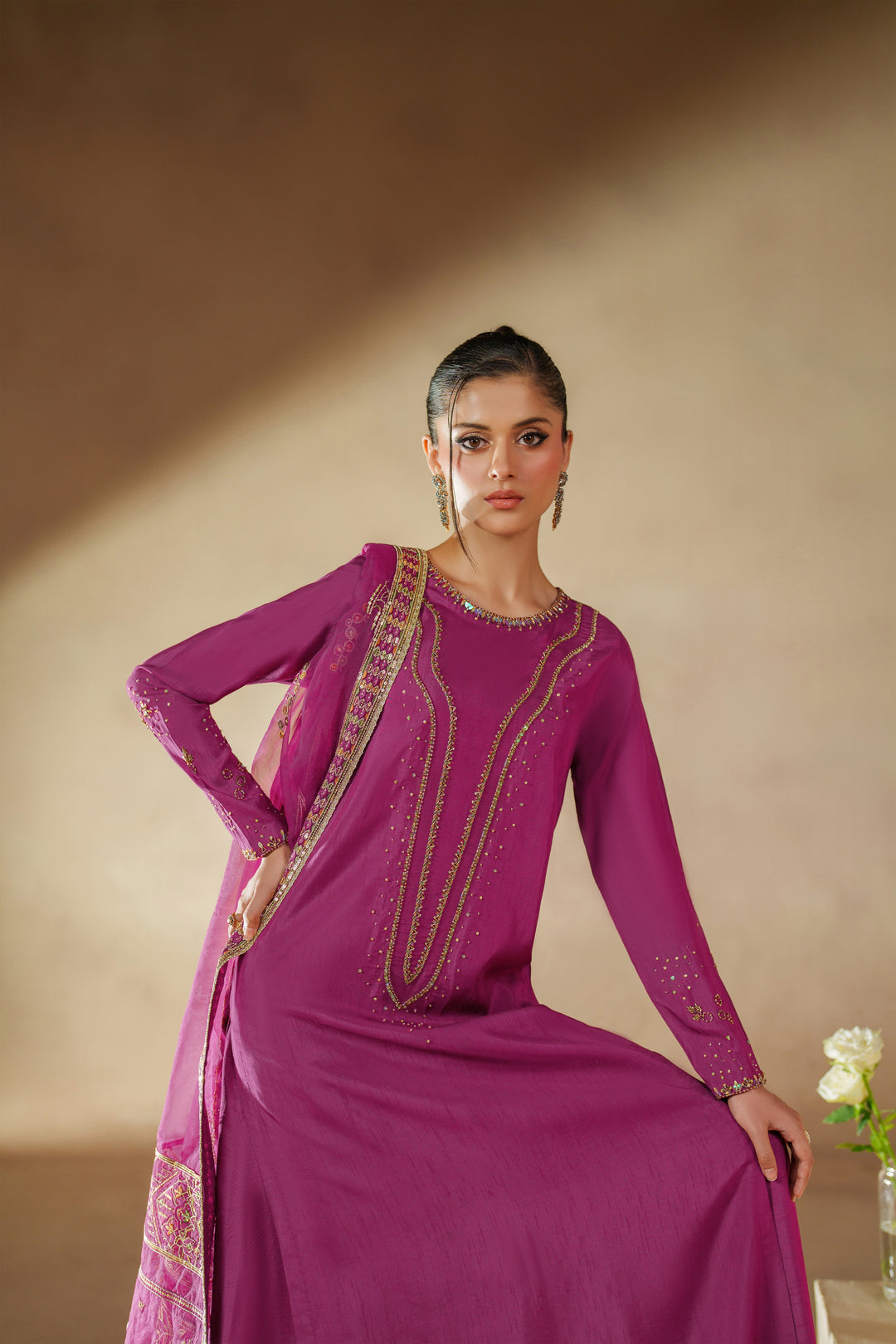 Seated pose of NAQSHI Imsha luxury pret outfit highlighting smooth raw silk fall, embroidered shirt, and elegant culotte fit.