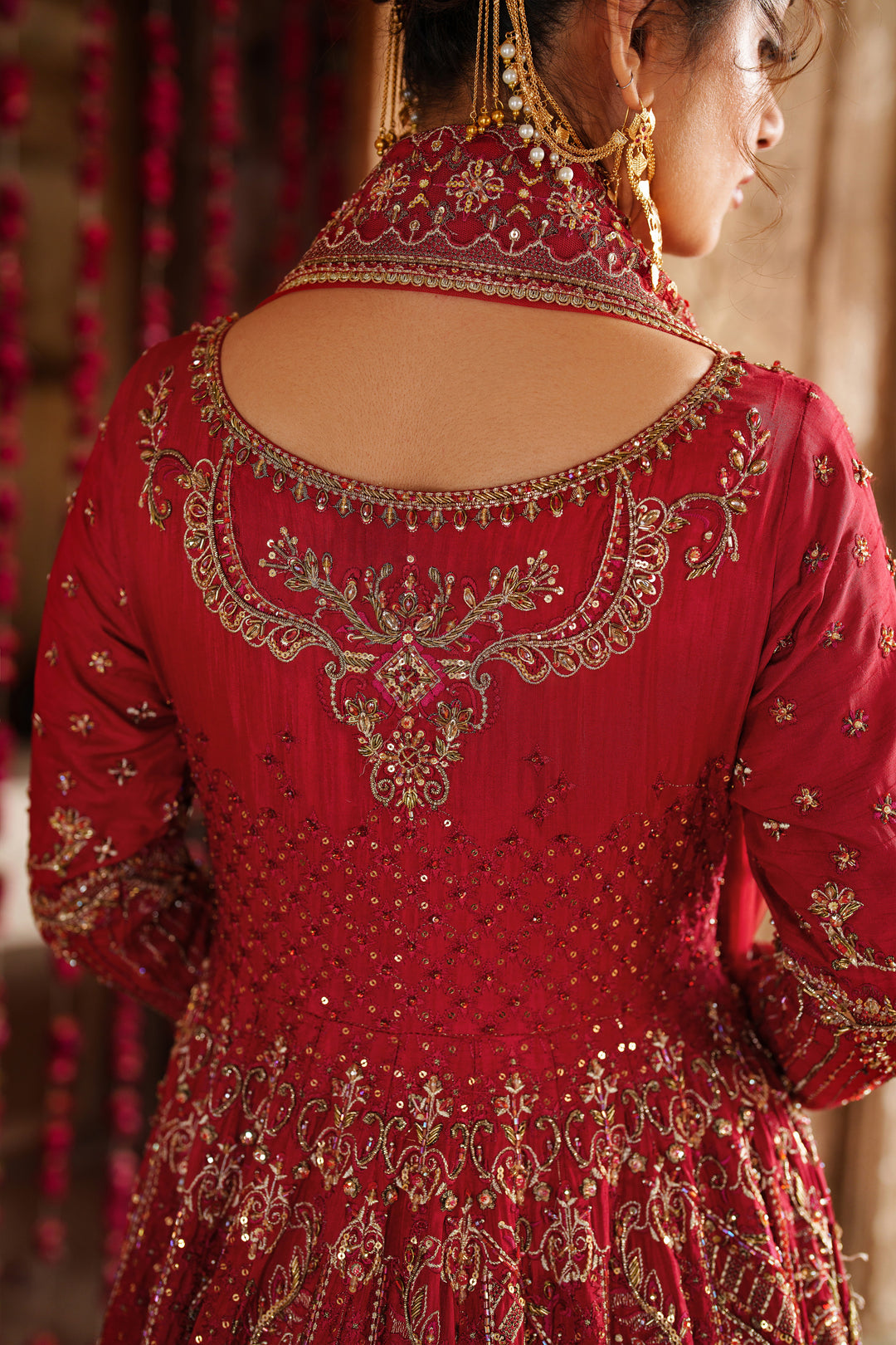 Close up embroidery and embellishment detail on NAQSHI Zeban red bridal lehenga blouse for formal bridal event wear.