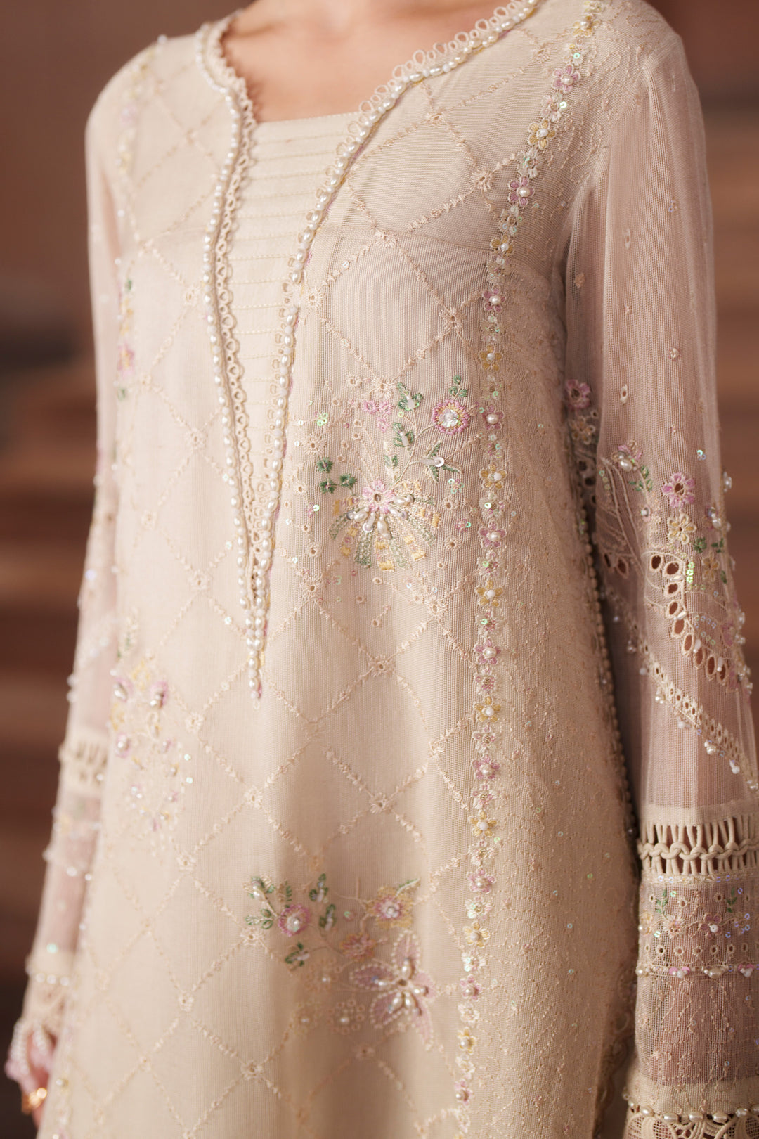 Close-up of Ingrid off-white embroidered khadi net shirt highlighting delicate sequin embroidery, panel detailing and refined neckline finish