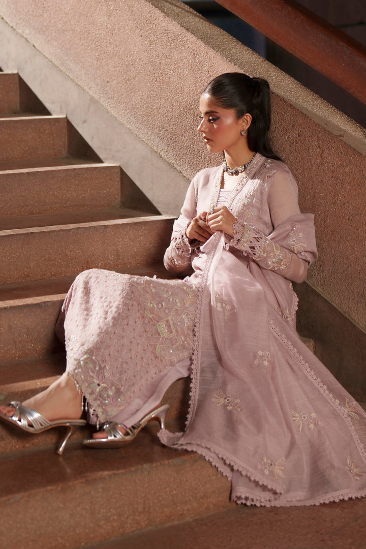 Seated styling shot of Anahi lilac embroidered evening wear outfit with khadi net shirt, raw silk culottes and delicate embroidered accents